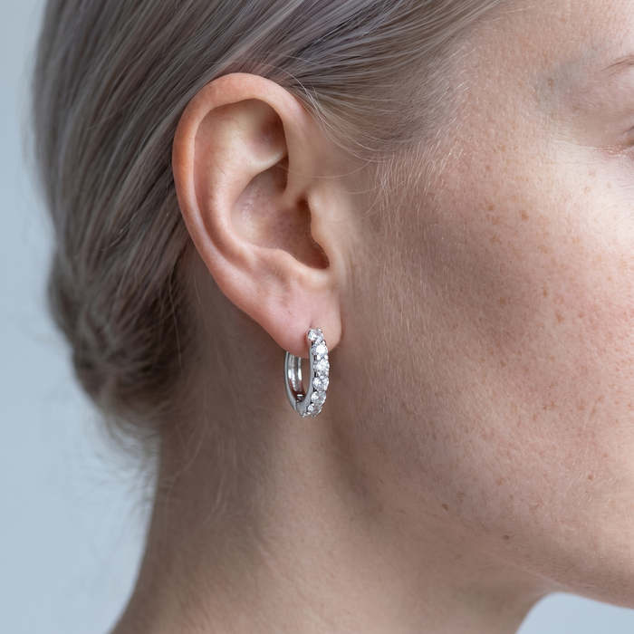 Close-up of the Aava silver stone mini hoop earring worn on the ear