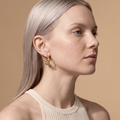 Model wearing the Aino gold-plated bubble hoop earring