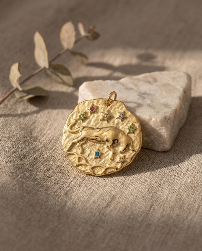 Taurus zodiac pendant styled on linen with marble
