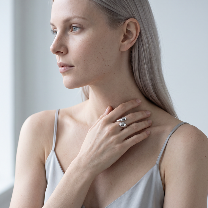 Model wearing the Ansa silver sculptural hug ring on her index finger