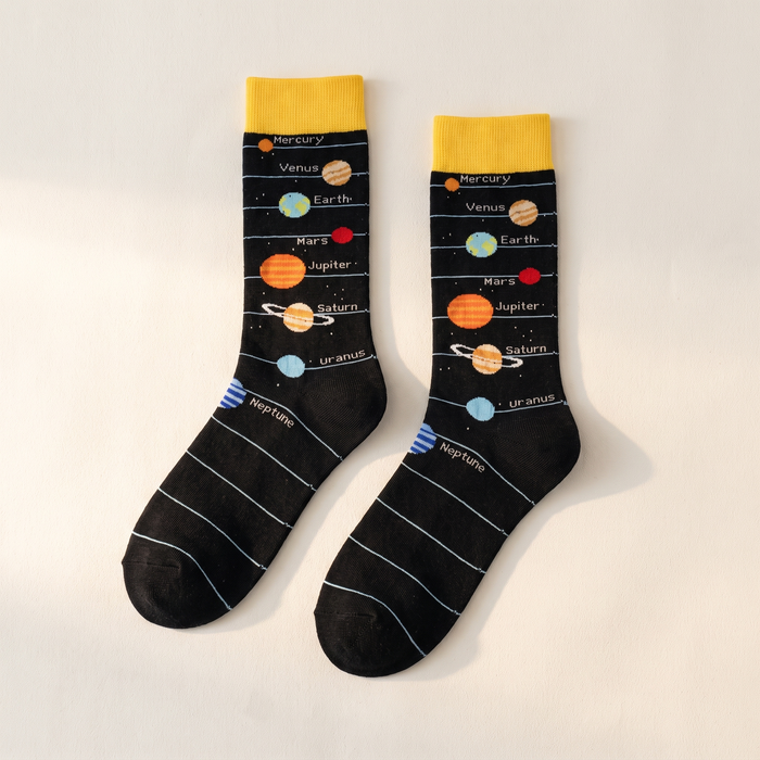 Planet and spaceship mid-calf socks laid flat on an off-white backdrop