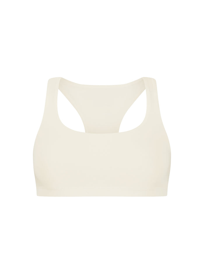 Cream sports bra on a white background