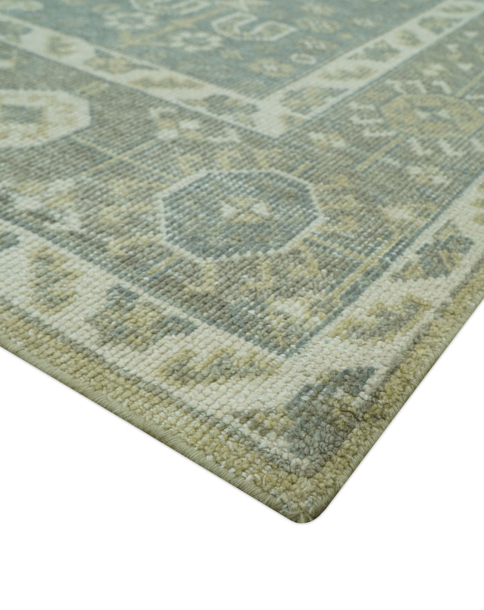 Traditional Turkish hand-knotted wool rug corner, sage green and cream diamond pattern texture