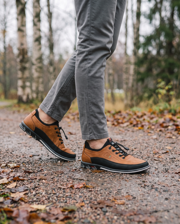 Tan casual leather shoes on an autumn park path