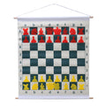 Demonstration chess set roll-up board with red & yellow stick-in pieces hanging on wall