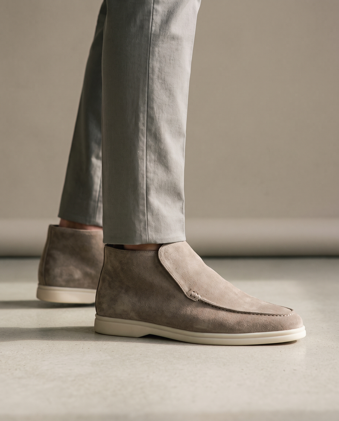 Taupe suede high-cut slip-on shoes worn on model