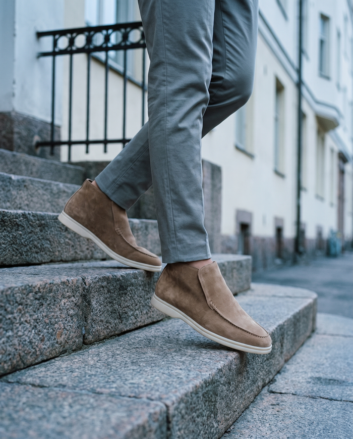 Taupe suede slip-ons on Helsinki granite steps