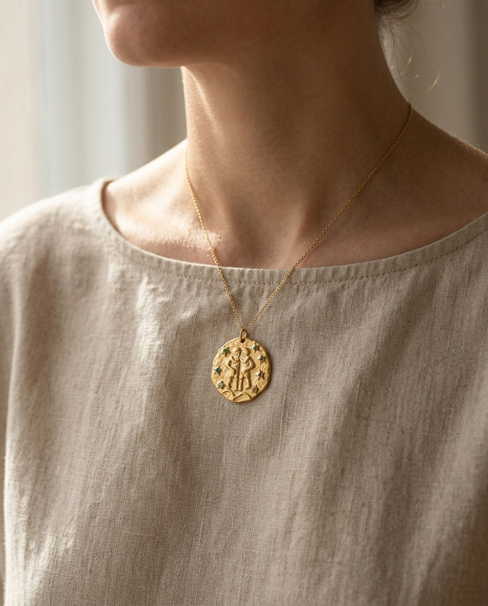 Gemini zodiac pendant worn on a fine gold chain