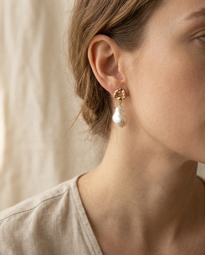 Baroque pearl drop earring worn on the ear