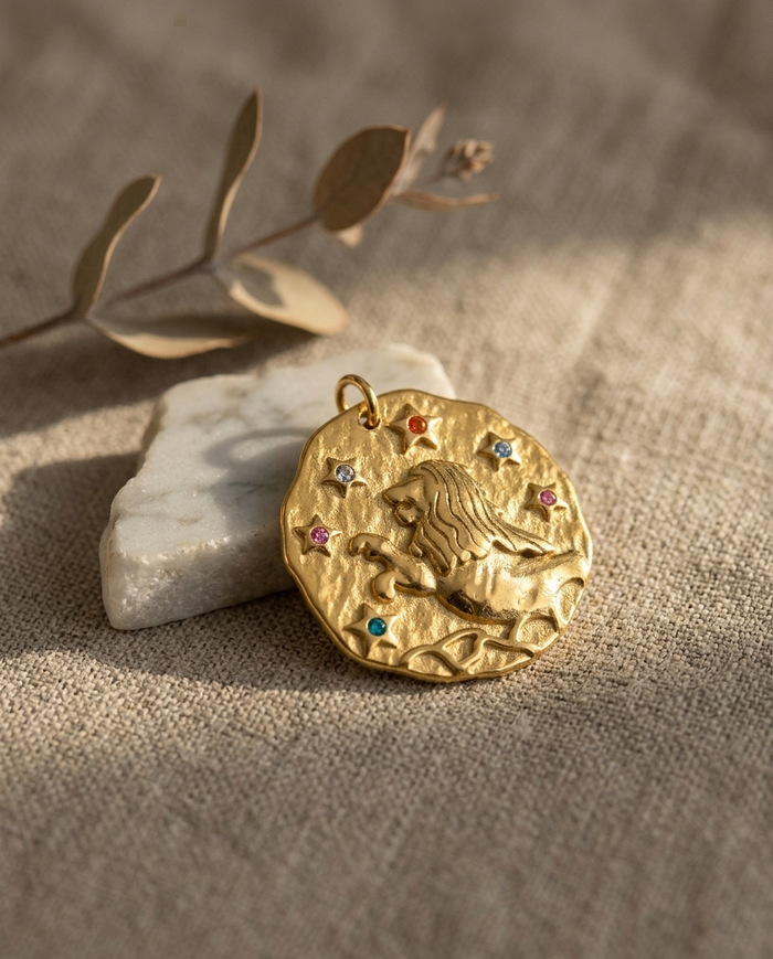 Leo zodiac pendant styled on linen with marble