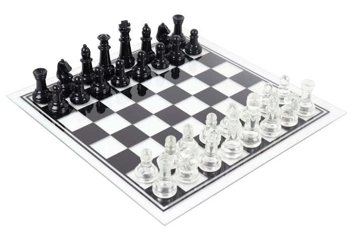 Black and clear glass chess set with pieces in starting position on glass chess board