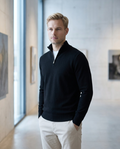 Black half-zip jumper worn in a Helsinki gallery interior