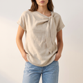 Hera blouse in sand beige, front view showing the knotted neckline detail
