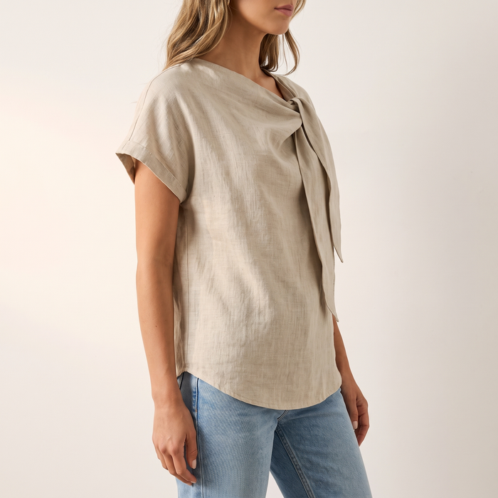 Hera blouse in sand beige, three-quarter view showing the sleeve and side drape