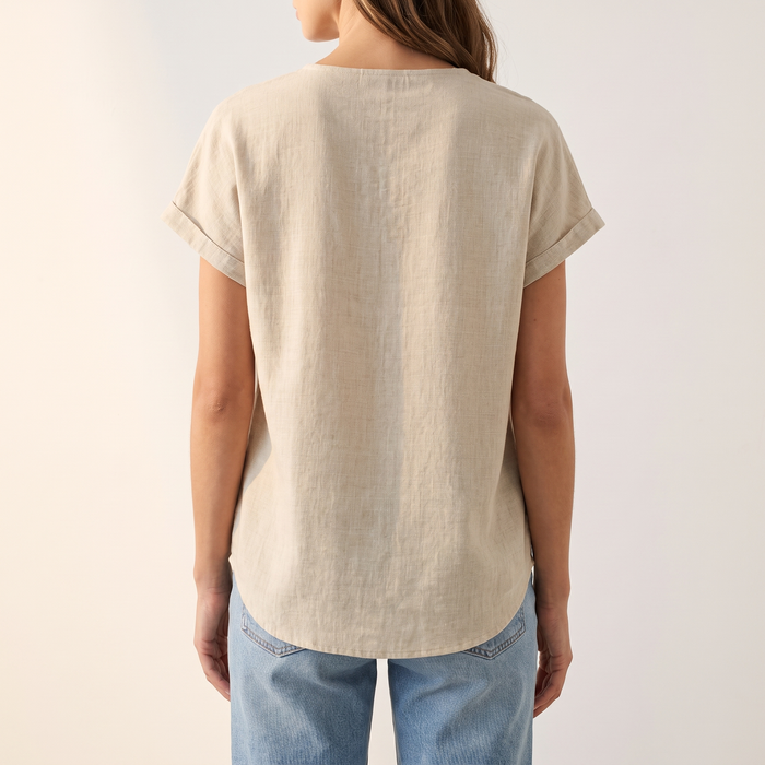 Hera blouse in sand beige, back view showing the drop shoulder and curved hem