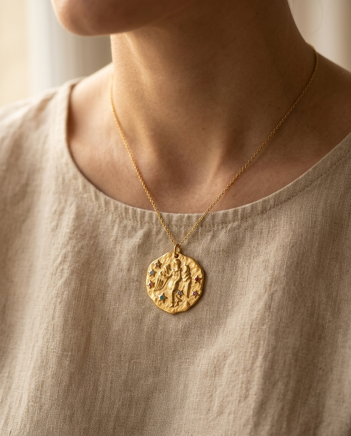 Virgo zodiac pendant worn on a fine gold chain