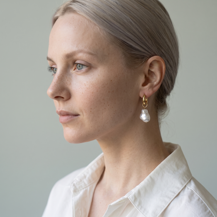 Model wearing the Hilla bold pearl hoop earring in profile
