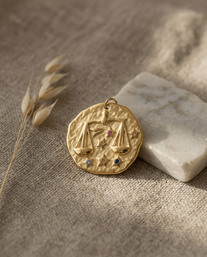 Libra zodiac pendant styled on linen with marble