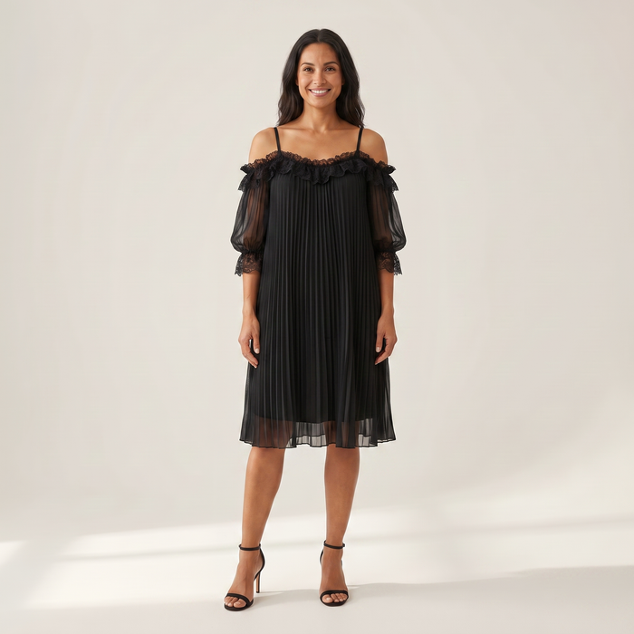 Woman wearing the Ilta black pleated chiffon dress with off-shoulder lace neckline, front view