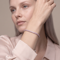 Model wearing the Meri pink tennis bracelet on her wrist