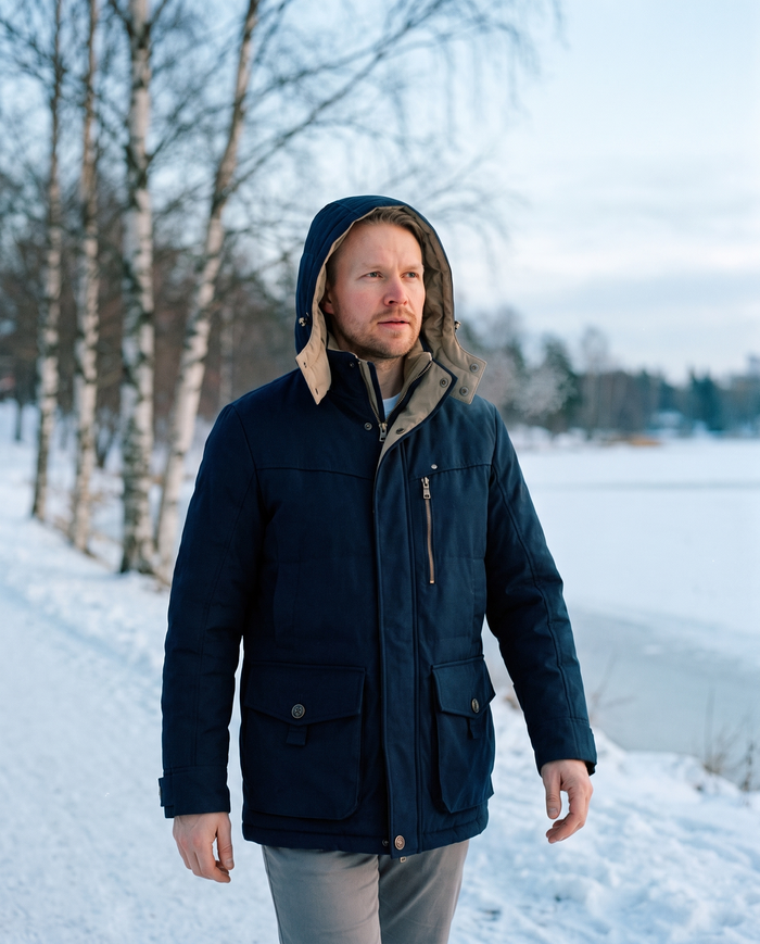 Padded winter jacket by frozen Toolonlahti bay Helsinki
