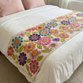 Quilted bed runner with scattered pastel daisies on off-white