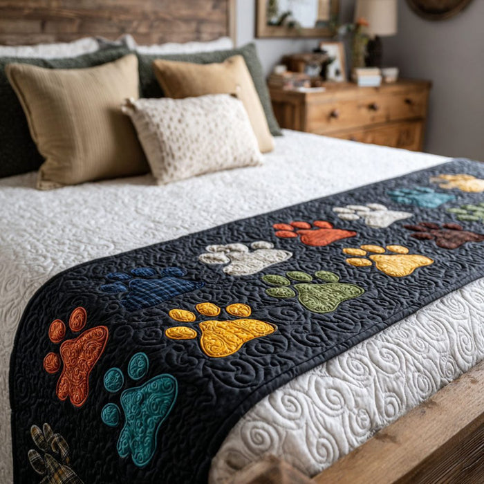 Quilted bed runner with colourful paw prints on charcoal