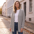 Grey open long cardigan worn over a white tee on a Helsinki street in autumn