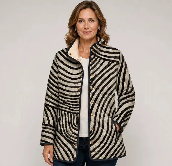 EMMA Pirkko quilted jacket in black and beige retro stripe, worn by a model