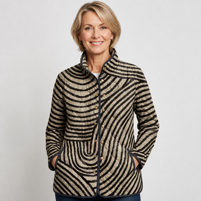 EMMA Pirkko quilted jacket in black and beige retro stripe, worn by a model