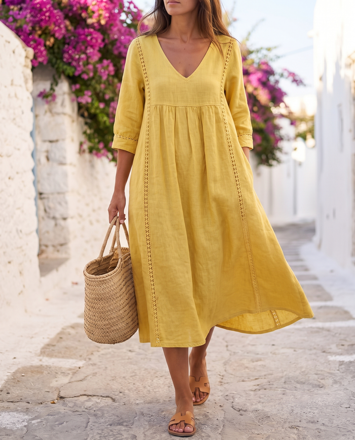 Saara V-neck lace-trim midi dress worn on a sunlit whitewashed coastal lane