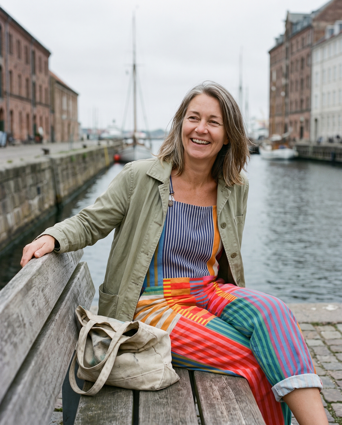 Sirkka printed wide-leg jumpsuit worn on a bench by the water