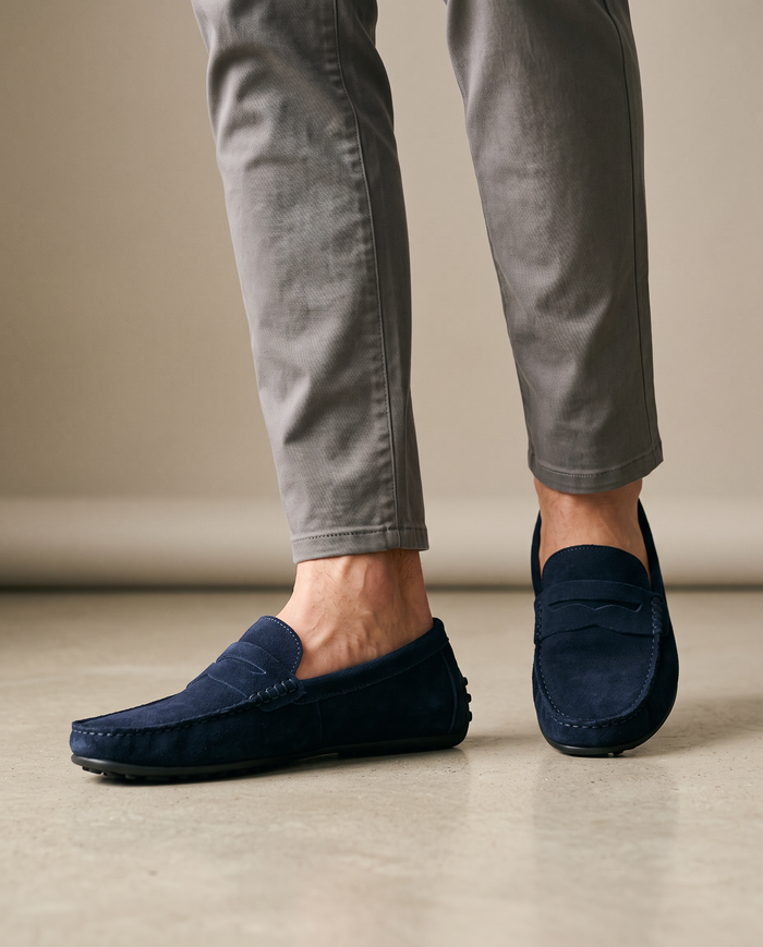 Navy soft suede moccasins worn on model
