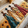 Quilted bed runner with figures in long dresses among sunflowers