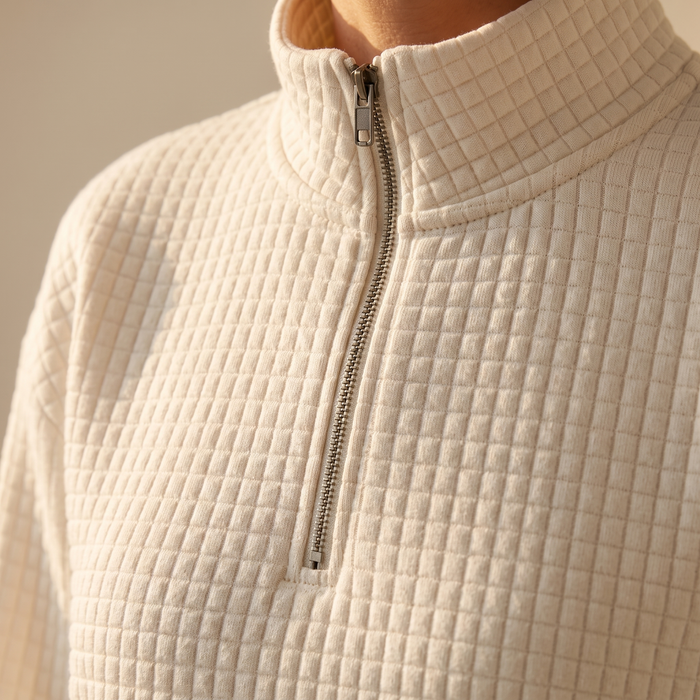 Close-up of the Usva fabric, showing the deep waffle grid, stand collar and half zip