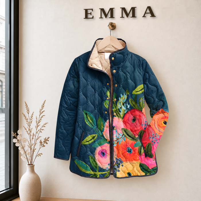 EMMA Vuokko quilted jacket in petrol blue poppy print, on a hanger in the EMMA boutique