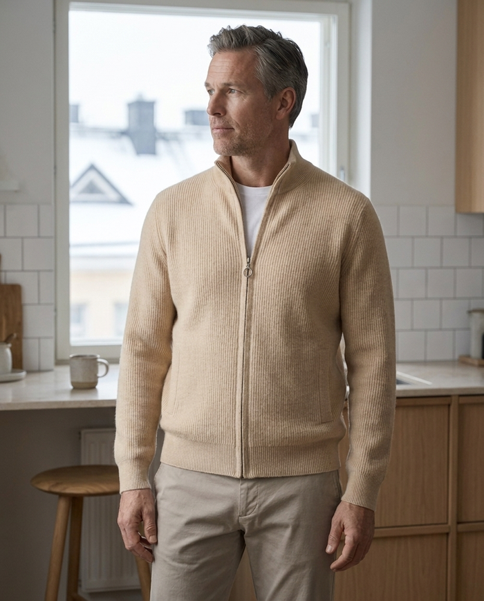 Cream zip cardigan worn in a pale Nordic kitchen